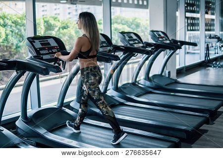 Young Fit Woman Doing Running Exercise In Gym