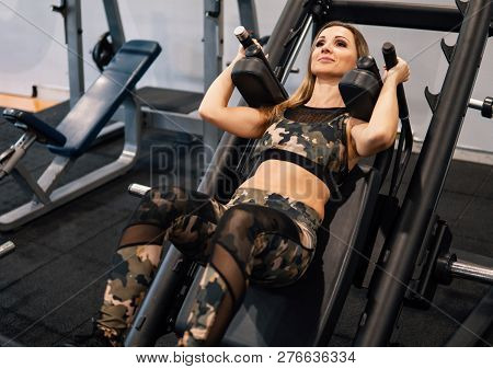 Young Fit Woman Doing Workout Exercise In Gym