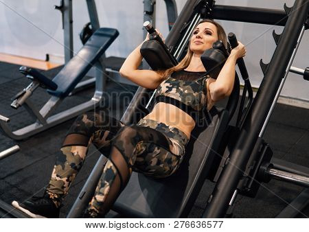 Young Fit Woman Doing Workout Exercise In Gym