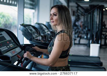Young Fit Woman Doing Running Exercise In Gym
