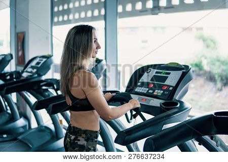 Young Fit Woman Doing Running Exercise In Gym