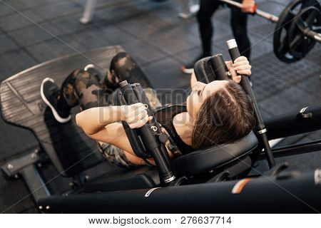 Young Fit Woman Doing Workout Exercise In Gym
