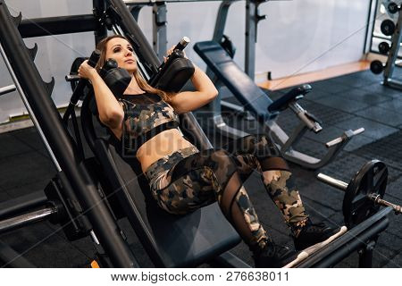 Young Fit Woman Doing Workout Exercise In Gym