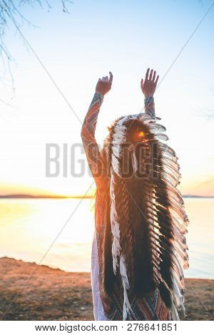 Back View Of Shamanic Young Girl With Indian Feather Hat Roach At Sunset
