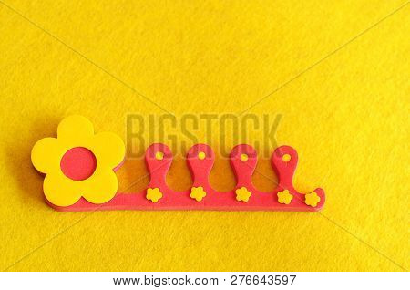 A Toe Separator On A Yellow Background