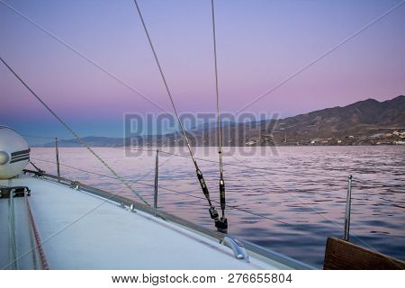 Colourful Mediterranean Sea Sunset View To Coast From Sailing Yacht