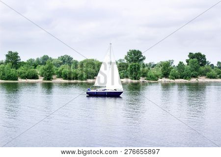 Sailboat Yacht Team Sailing With Full Sails Throught The Wind On Lake