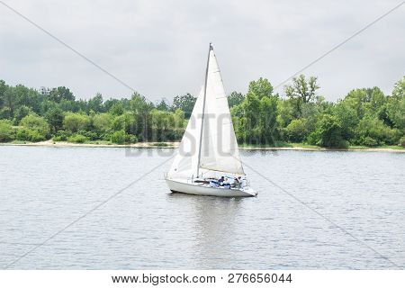 Sailboat Yacht Team Sailing With Full Sails On River Lake