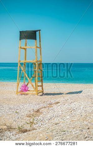 Sunshade Umbrellas And Deckchairs On The Beautiful Beach In Himara, Turquoise Water Of Ionian Sea In