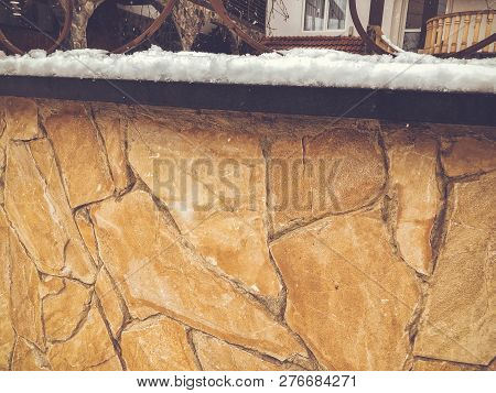 Srone Gate With Decorative Steel Trim. Snowfall On The Street.noon.