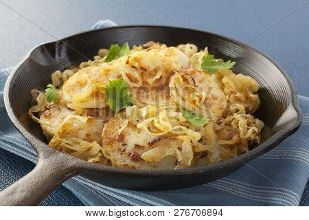 A Classic French Vegetable Dish, Lyonnaise Potatoes, Sliced Potato Fried With Onion, In A Cast Iron 