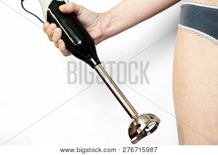 Blender In Female Hand On A White Background. Cooking. Unusual Cuisine.