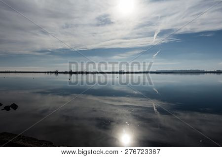 Lake Of The Flooded City Of Epecuen. The Sun Is Reflected In The Water Between The Clouds. Uniric La