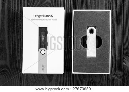 UKRAINE, ROVNO - ON DECEMBER 2: Ledger hardware wallet for cryptocurrency on a wood background
