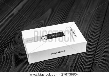 UKRAINE, ROVNO - ON DECEMBER 2: Ledger hardware wallet for cryptocurrency on a wood background