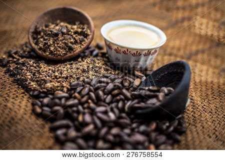 Close Up Of Paste Of Custard Apple Seeds In A Glass Bowl With Some Powdered Seeds And Raw Dried Seed