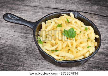 Pan With Spatzle On Old Wood Table