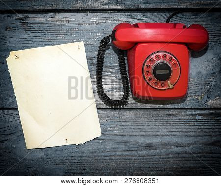 Vintage Red Phone And A Piece Of Paper To Write