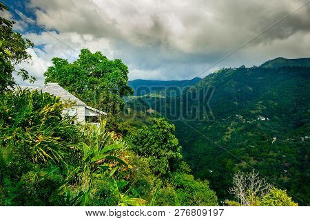 Kingstown Hill, Jamaica, Dec 2018, Caribbean-style House Surrounded By A Lush Vegetation In The Blue