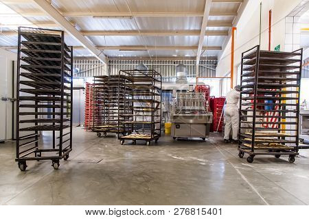 Johannesburg, South Africa, 12 December - 2018: Industrial Bakery With Racks For Fresh Baked Bread.