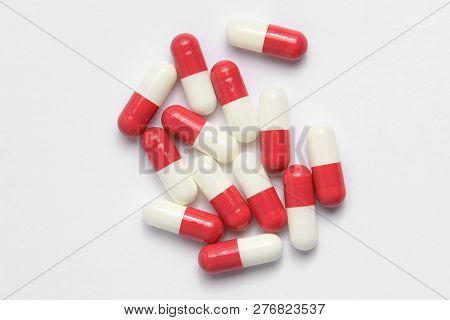 Medicine In Cylindrical Capsules Of Red Color On A White Background