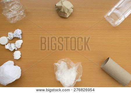 Top View Of Recycling Garbage Waste On Wooden Background With Center Copy Space , Eco And Save World