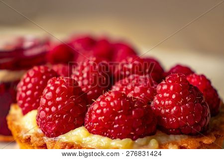 Juicy Ripe Raspberries On A Cake-tartlet Close-up
