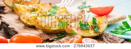 Slices Of Baked Potatoes With Spices And Herbs On The Bark Of A Tree