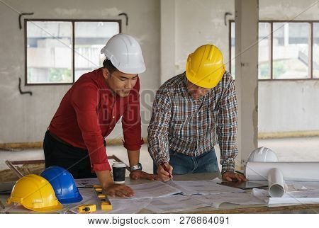 Team Of Architects People In Group On Construciton Site Check Documents And Business Workflow