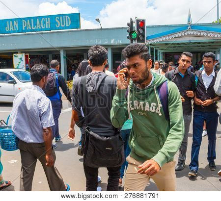 Curepipe / Mauritius Island - 28. October, 2018: Many young people walking on pedestrian crossing. Jan Palach bus station named on honor of Czech student hero who burnt to death in 19.january 1969. 