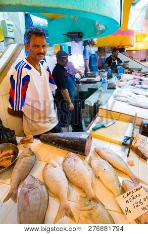 Curepipe / Mauritius Island - 28. October, 2018: Unidentified native fisherman selling his fish catch on traditional city market.