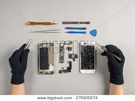 Technician Or Engineer Disassembling Components Broken Smartphone For Repair Or Replace New Part On 