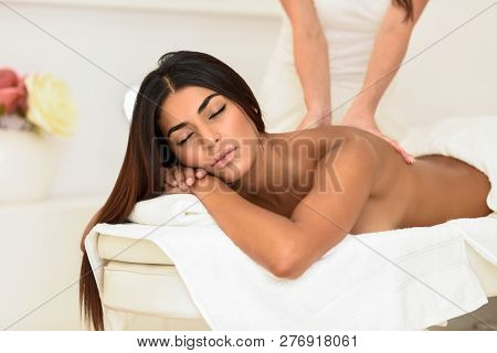 Arab Woman Receiving Back Massage In Spa Wellness Center.