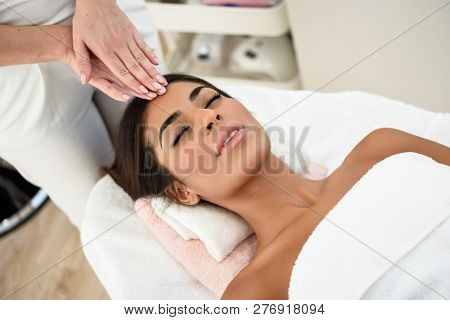 Woman Receiving Head Massage In Spa Wellness Center.