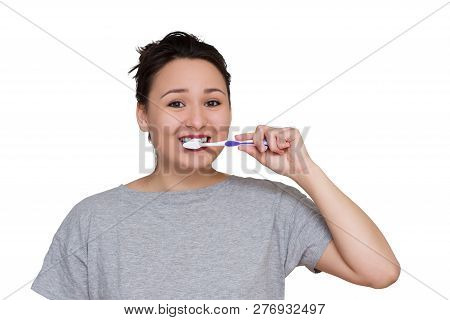 A Pretty Young Girl Brushing Her Teeth