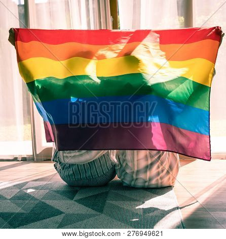 Gay Couple Romantic Moment Under Lgbt Flag.