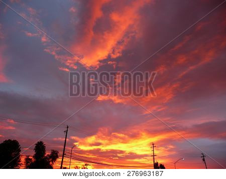 Dramatic Sunrise With Orange And Yellow Streaks