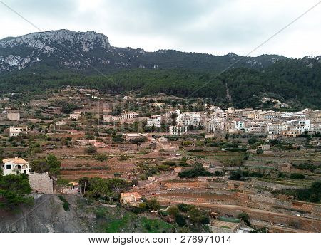 Aerial Drone View Of Small Hillside Banyalbufar Town On West Coast Of Mallorca. Surrounded By Tramun