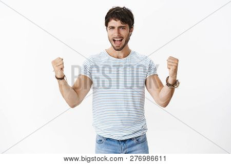 Waist-up Shot Of Supportive And Cheerful Good-looking Male With Blue Eyes And Bristle In Striped T-s
