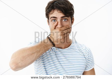 Stunned And Concerned Handsome Guy Feeling Intense And Worried Covering Mouth With Palm As Realising