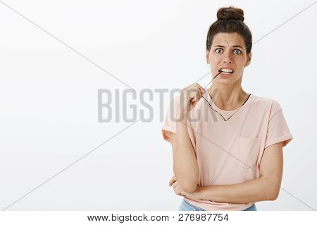 Overthinking Worried And Insecure Good-looking Young Female Newbie Frowning Biting Frame Of Glasses 