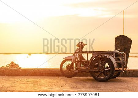 Sidecar Motorcicle Near The Sea With Sunset.