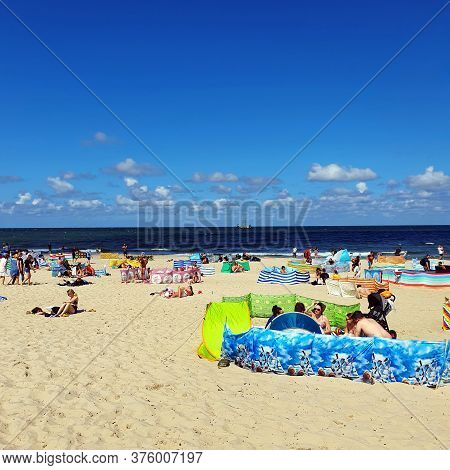 Wladyslawowo, Poland - July 12, 2020: People Are Resting On The Beach On A Sunny Day In Wladyslawowo