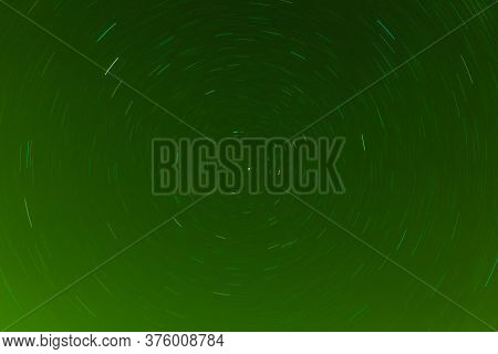 Background Of Round Or Circular Star Track Or Trajectory On The Green Clear Night Sky. Symbol Of Spa