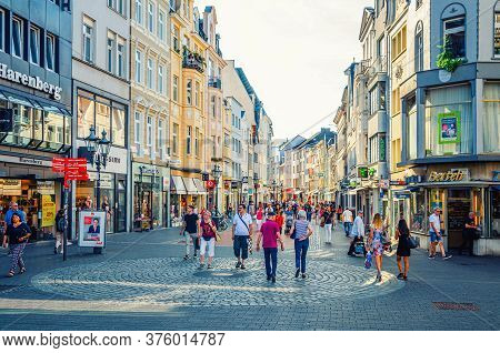 Bonn, Germany, August 23, 2019: People Tourists Walking Down Cobblestone Street In Historical City C