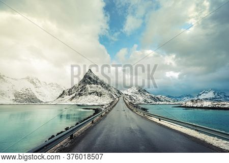 Olstind Mount and asphalt road. Lofoten islands, spring time, Norway
