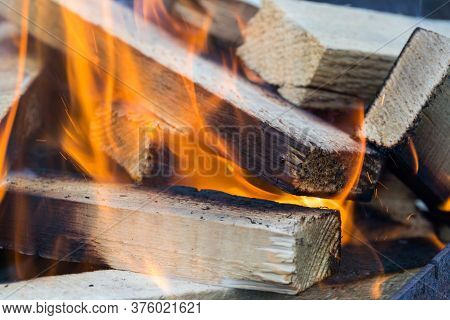Flame Incinerates Firewood And Transforms It Ashes, Close Up, Shallow Depth Of Field. Blaze In A Lar
