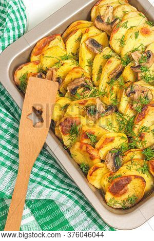 Potato Wedges Baked With Mushrooms, Herb Oven Roasted, With Thyme, A Close-up In A Baking Tray. Top 