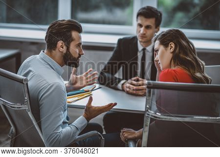 Three Business Partners Discussing Their Current Projects