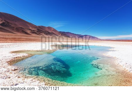Salt water pool in Salinas Grandes Salt Flat - Jujuy, Argentina. Unusual natural landscapes.